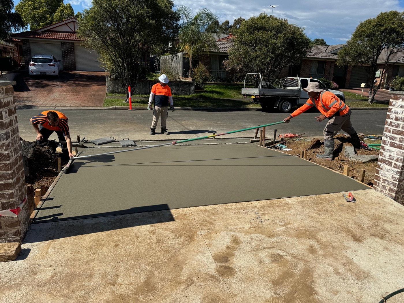 Screeding a new concrete driveway